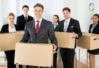 Employees-In-Office-Holding-Cardboard-Boxes