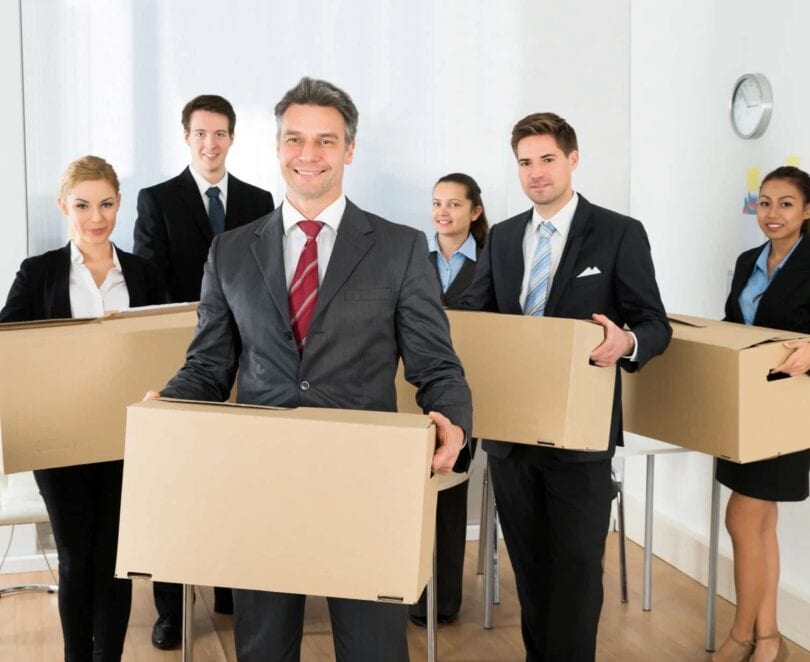 Employees-In-Office-Holding-Cardboard-Boxes