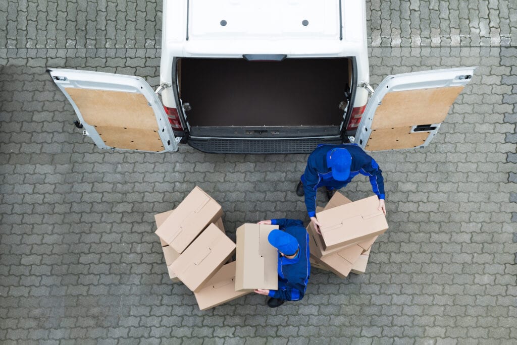 aerial photo of movers with boxes at moving truck