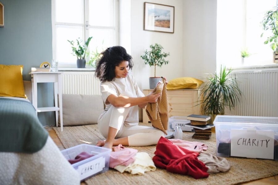 woman sorting through decluttering piles