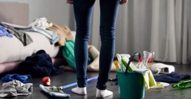 woman standing in messy room