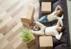 couple relaxing with moving boxes