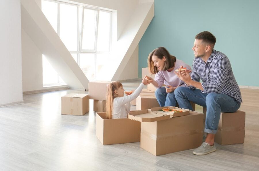 family with moving boxes and pizza