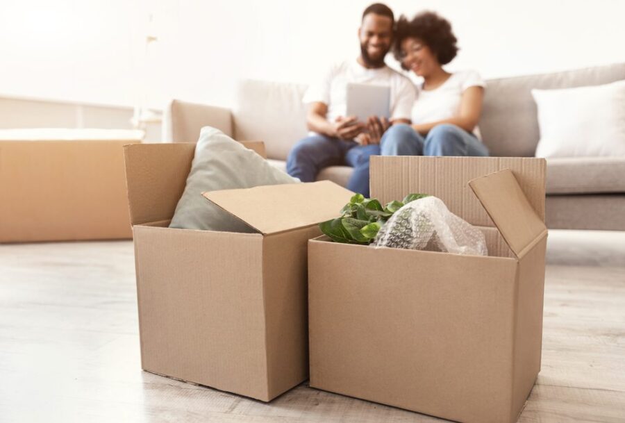 couple in background with boxes on tablet