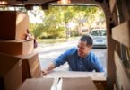 happy man loading boxes into truck