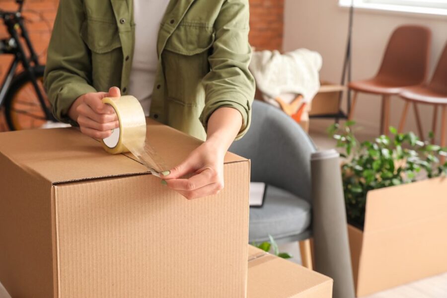 moving boxes closeup person taping