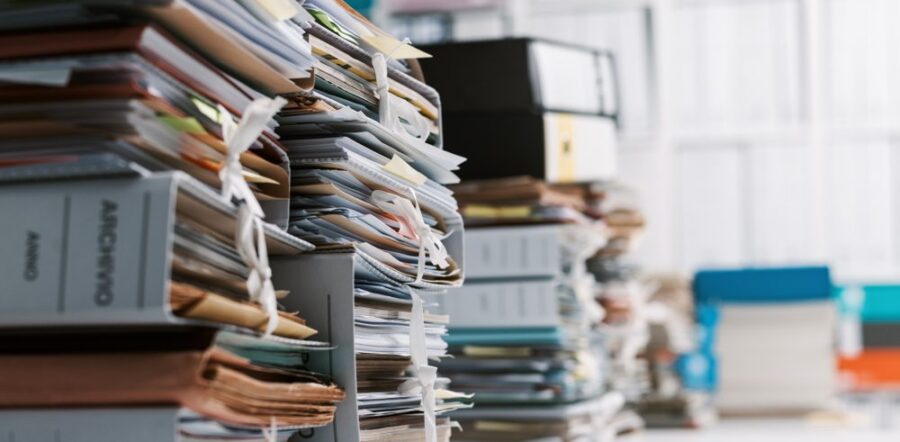 stack of office papers and binders