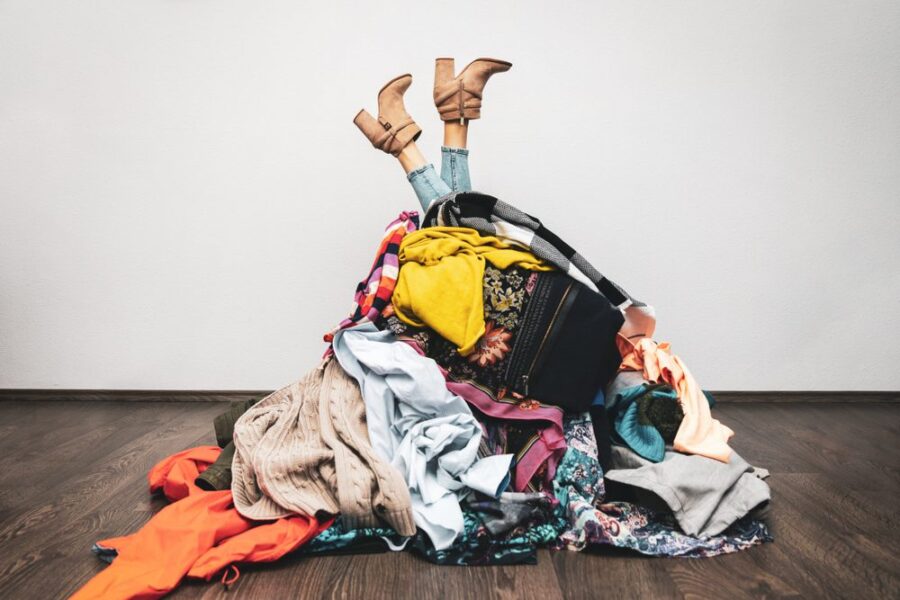 woman in clothing pile