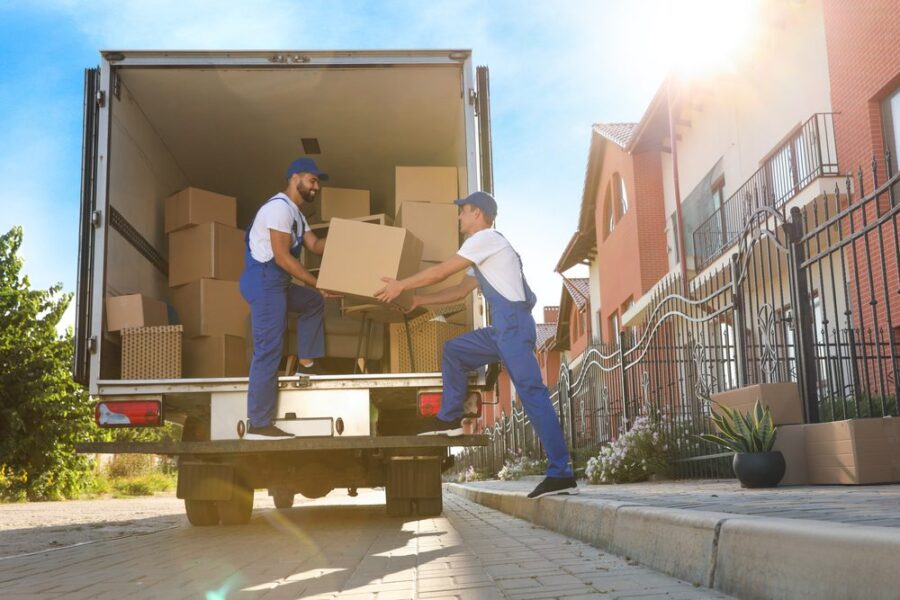 movers with boxes outside of apartment