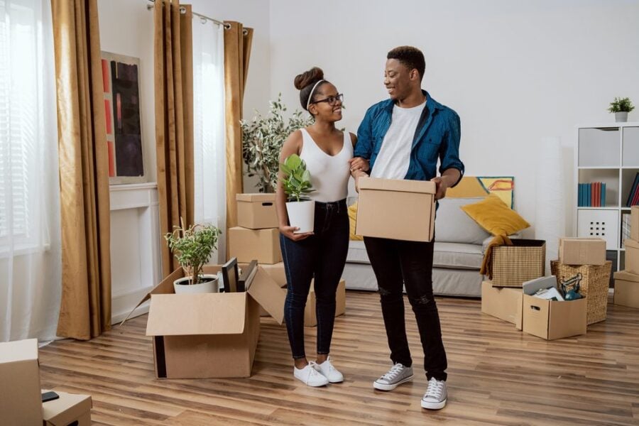 smiling couple packed moving boxes