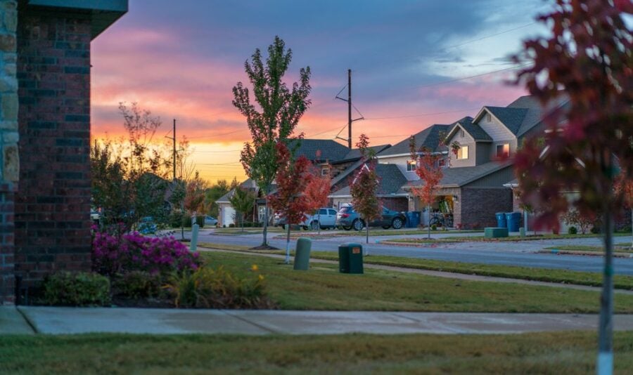 suburban street with sunset and large homes