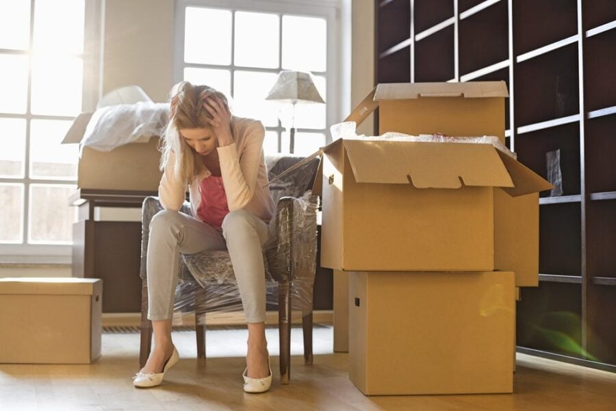 woman stressed with moving boxes