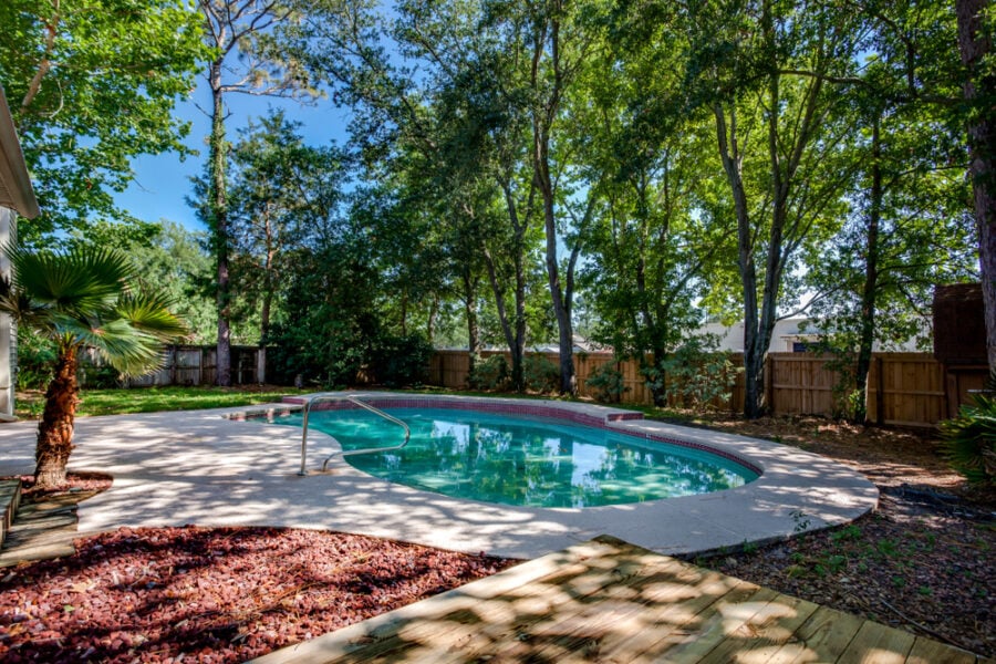 beautiful backyard with swimming pool and garden