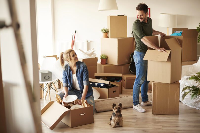 couple unpacking moving boxes in their home